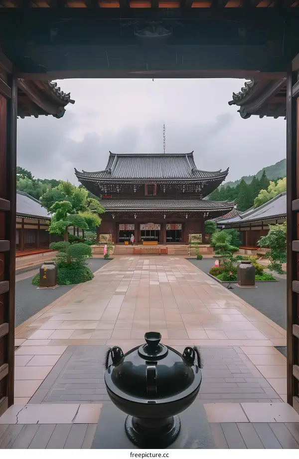 Traditional Japanese Temple Courtyard with Black Pot in Foreground