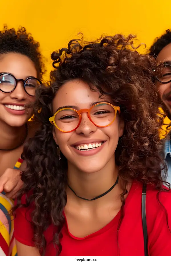 Smiling Woman With Curly Hair Wearing Glasses