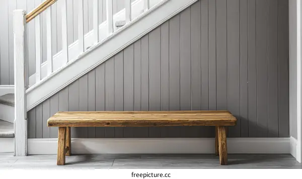 Wooden bench in a hallway with stairs