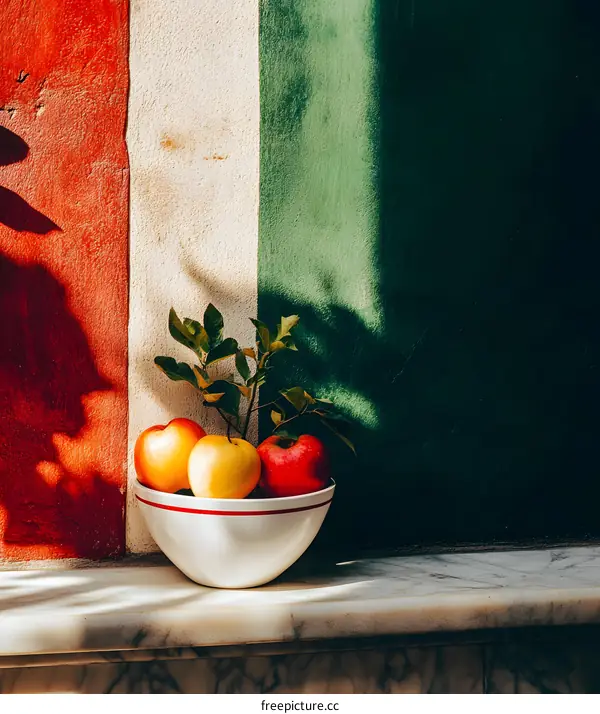Still Life Photography of Apples in a White Bowl Against a Red, White, and Green Wall