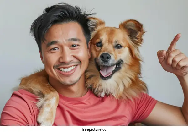 Asian man with dog smiling at camera