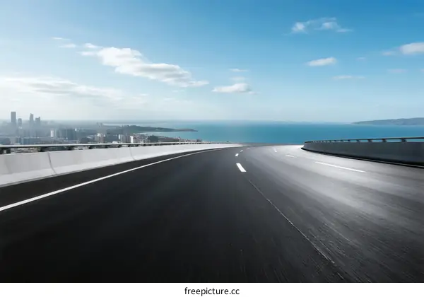 Smooth highway with city and sea view in the distance