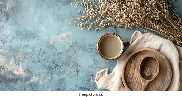 Rustic Tabletop Still Life with Dried Flowers, Wooden Plate and Cup of Coffee