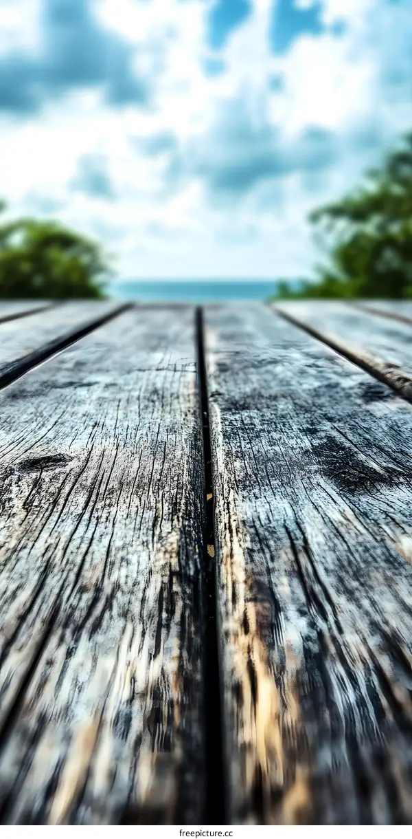 Close Up of Weathered Wooden Deck with Blurred Sky and Sea in the Background