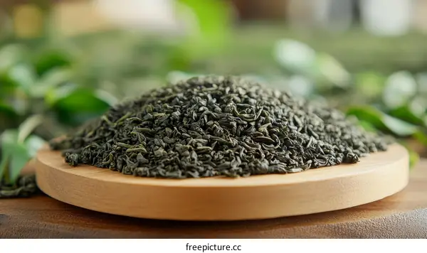 Pile of Green Tea Leaves on Wooden Tray