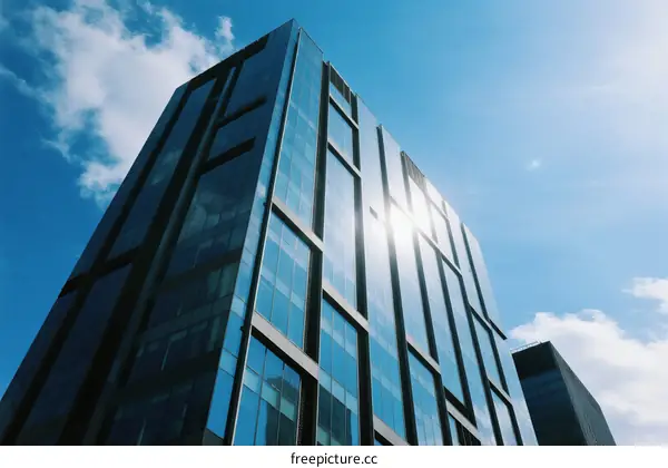 Modern glass building under a clear blue sky
