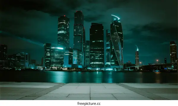 Night view of modern city skyscrapers with illuminated buildings