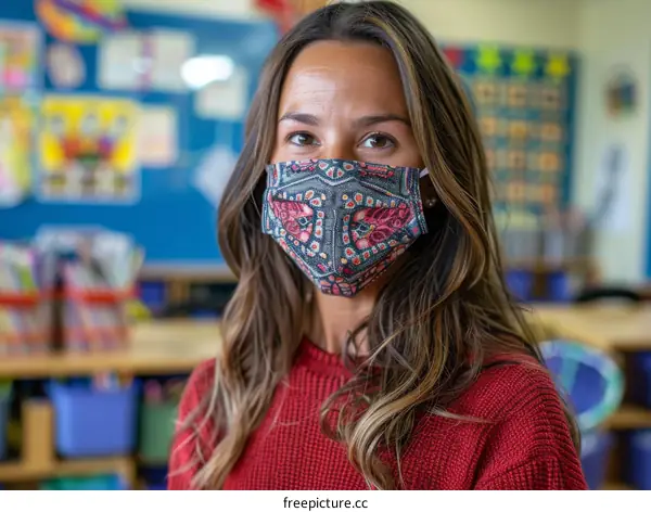 Portrait of a young female teacher wearing a facial mask in a classroom