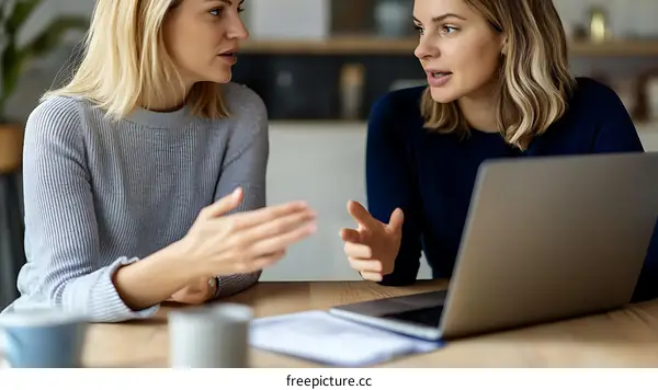 Two Caucasian Women in Conversation at a Table