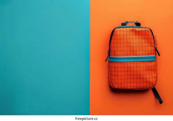 A stylish orange and blue backpack against a blue and orange background