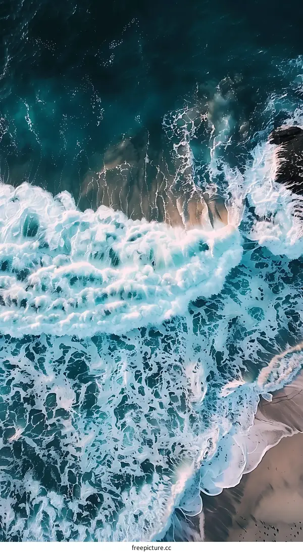 Aerial View of Waves Crashing on the Beach