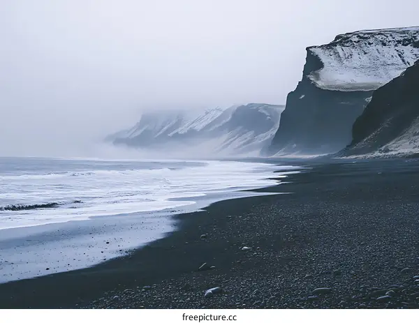 Black Sand Beach with Misty Cliffs and Waves