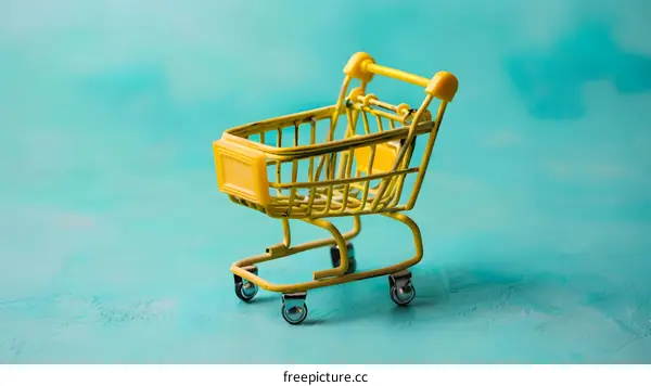 Yellow Shopping Cart on Turquoise Background
