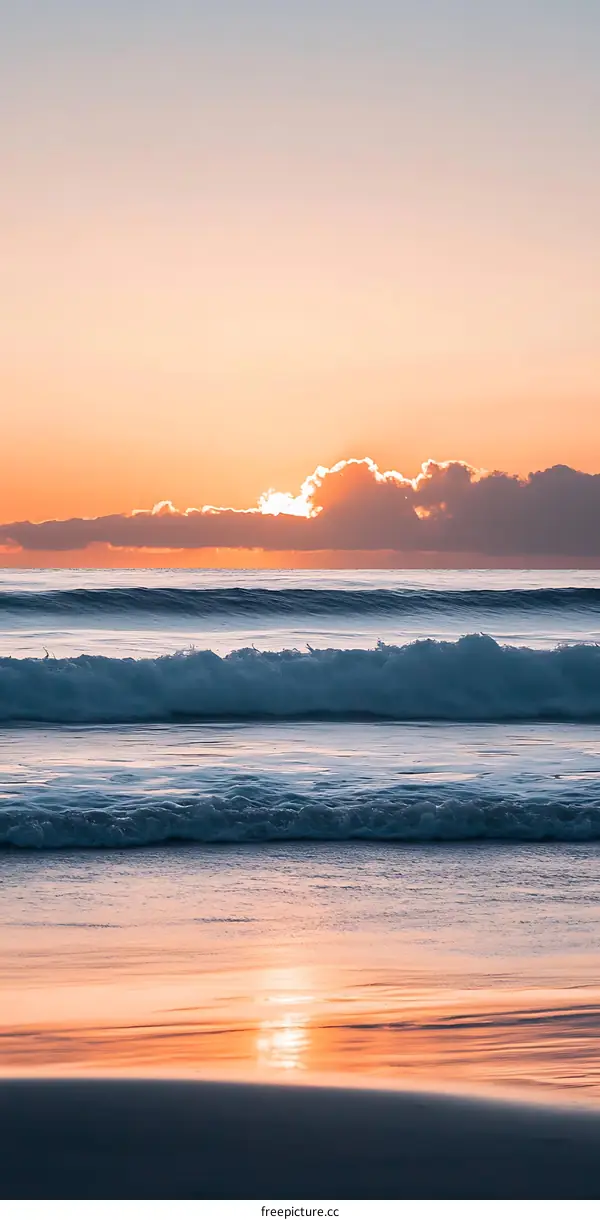 Beautiful Sunset Over the Ocean with Waves Crashing on the Beach