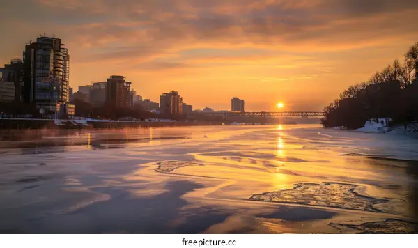 Frozen River with Sunrise and City Skyline in the Morning
