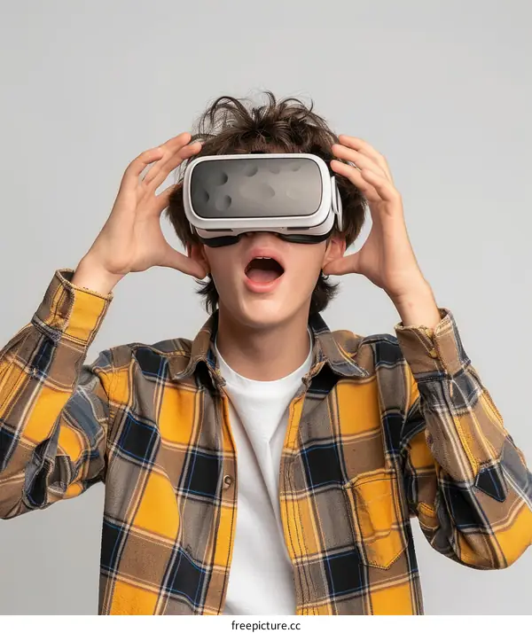 Young male caucasian teenager wearing virtual reality headset