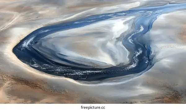 Aerial View of a Winding Riverbed in a Desert Landscape
