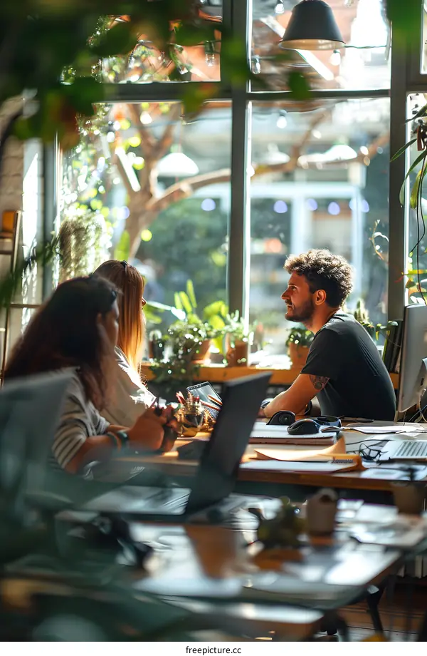 three people in a bright room talking