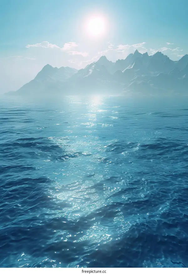 The sun shines on the sea and the mountains in the distance