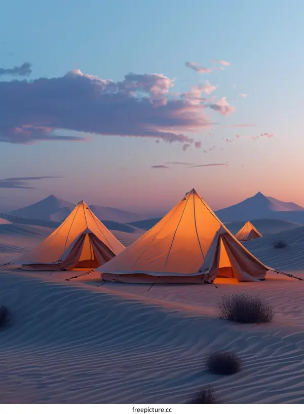 Illuminated Tents Amidst the Serene Desert Landscape at Dusk