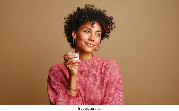 Smiling Woman Holding Skincare Product
