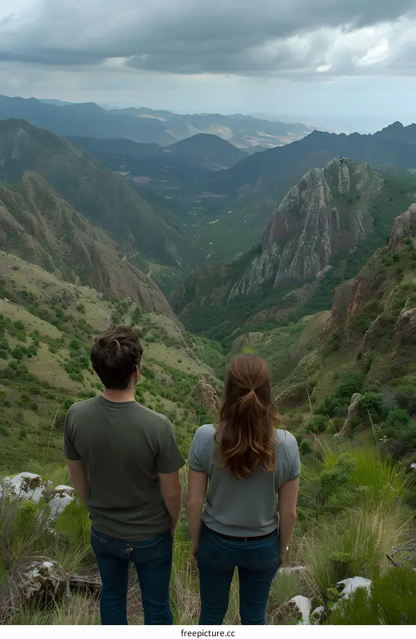 Couple Standing On Top of Mountain Range