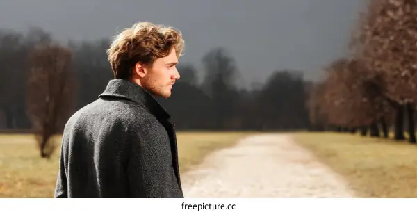 Man in a Gray Coat on a Country Path