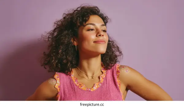 Portrait of a Woman with Curly Hair against a Purple Background