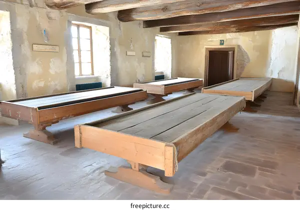 Wooden Tables in an Old Room with Stone Walls