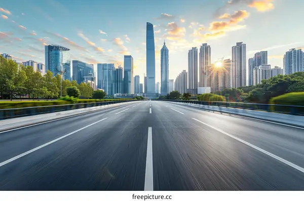 Empty Asphalt Road Cutting Through a Modern Urban City at Sunrise