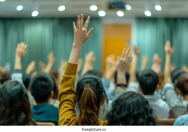 people raising their hands in a conference