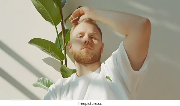 Man in White Shirt Looking Up at Camera