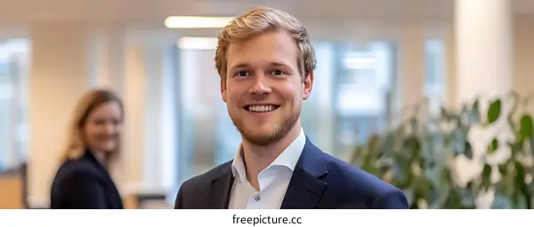 Portrait of a Young Caucasian Man Smiling in a Business Suit