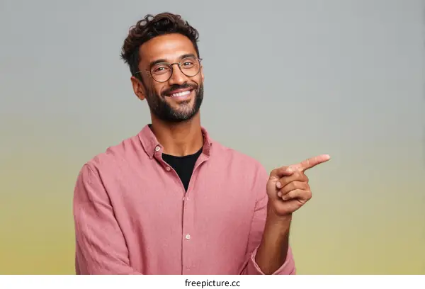 Smiling Man in Pink Shirt Pointing