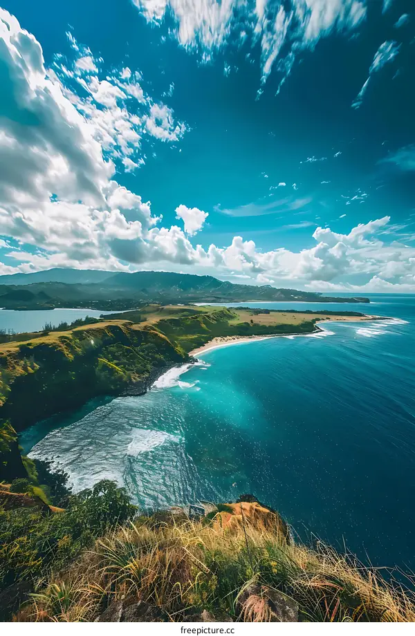 Aerial View of Green Coastline with Blue Ocean and White Clouds
