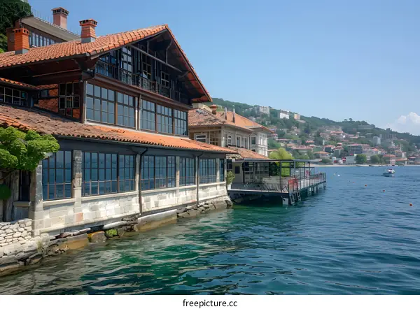 Waterfront Building with Red Roof and Large Windows