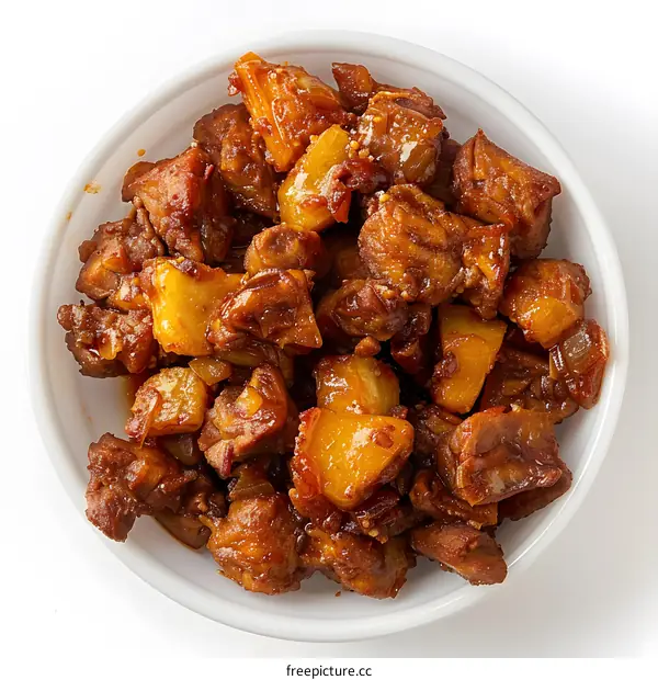 A plate of diced chicken with pineapple