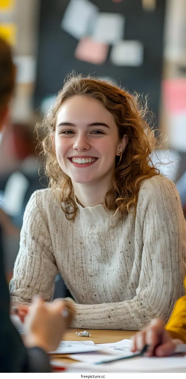 Smiling Woman with Curly Hair in a Group Discussion