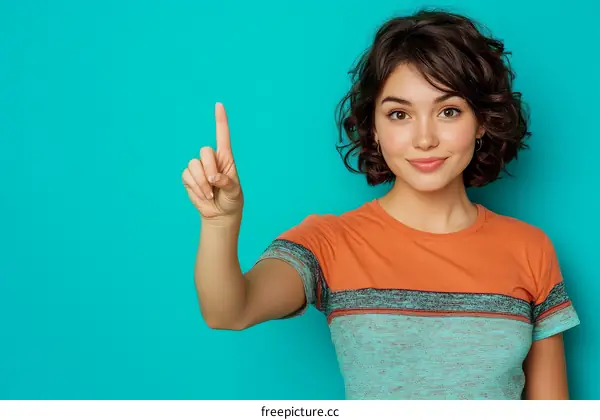 Woman Pointing Upward on Teal Background
