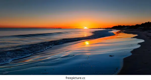 Sunset Over Ocean With Sandy Beach