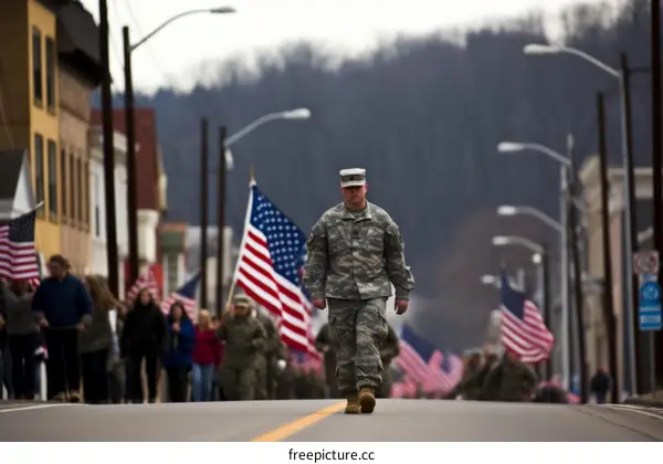 Soldier walking in a parade with American flags