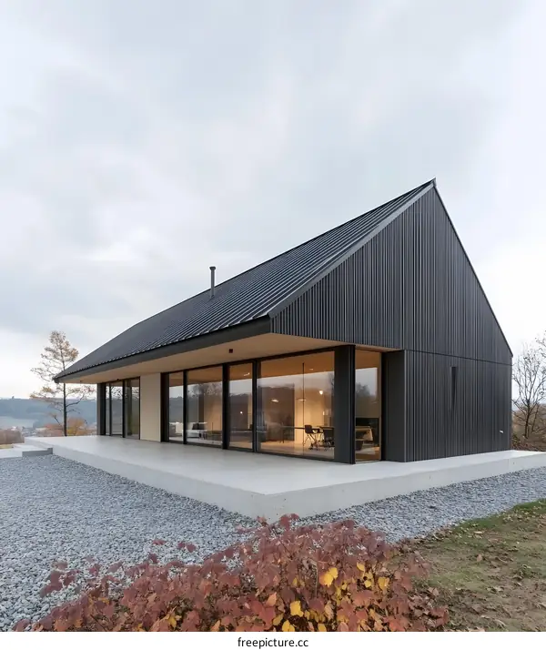 Modern Black House with Large Windows and Gravel Patio