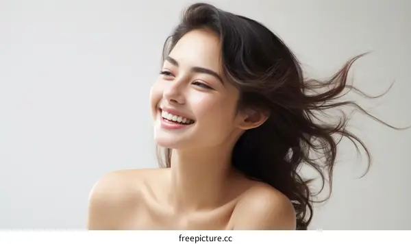 Portrait of a beautiful young woman with long brown hair smiling