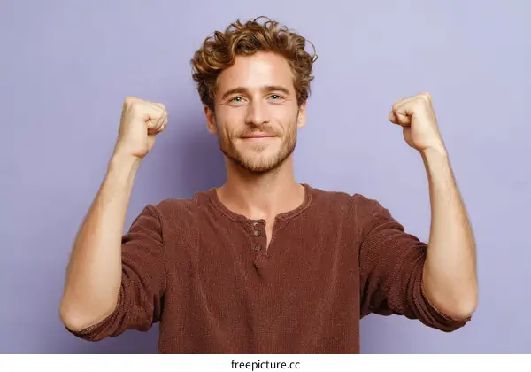 A Young Man Flexing Muscles Against Purple Background