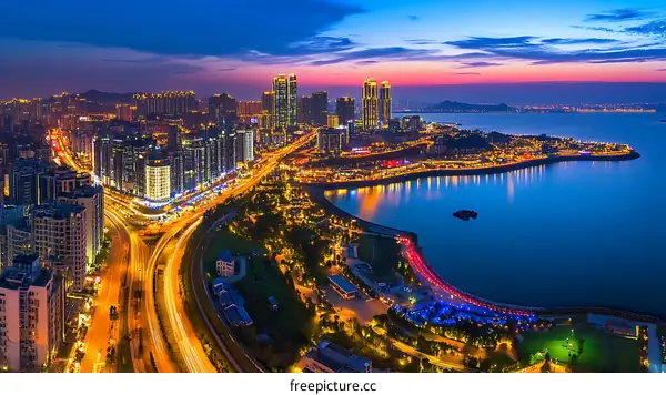Panoramic View of a Coastal City at Night