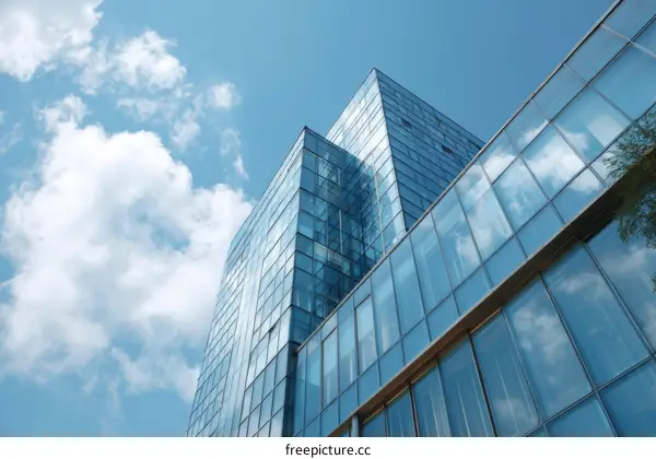 Modern Glass Facade of a Skyscraper Against a Blue Sky