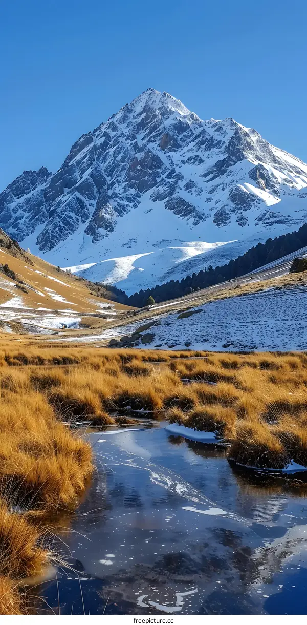 Snowy Mountain Peak with Frozen Stream in the Valley
