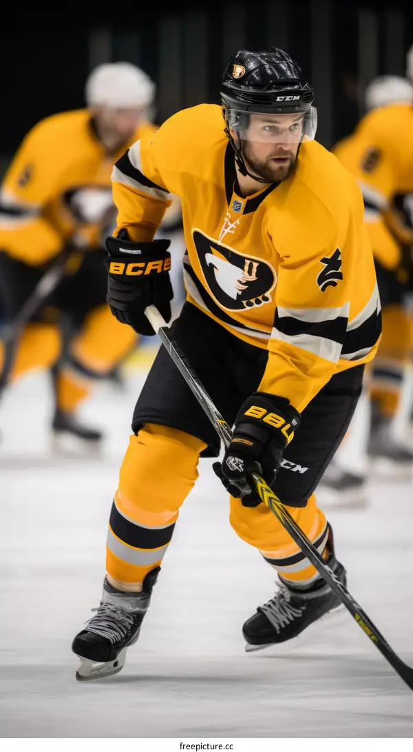 Ice hockey player in yellow and black uniform skating on ice