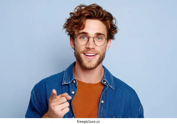 Smiling Man in Jeans Jacket Pointing