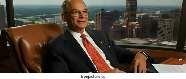 Businessman Sitting in Office Chair with City View